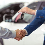 Person receiving keys to used car